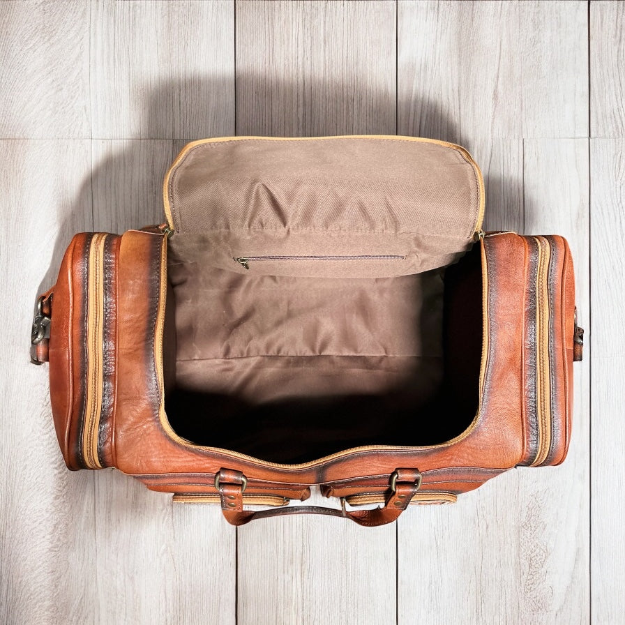 Floral tooled leather duffle bag