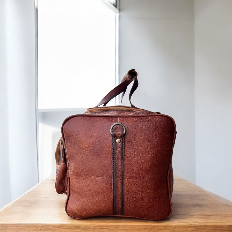 Floral tooled leather duffle bag