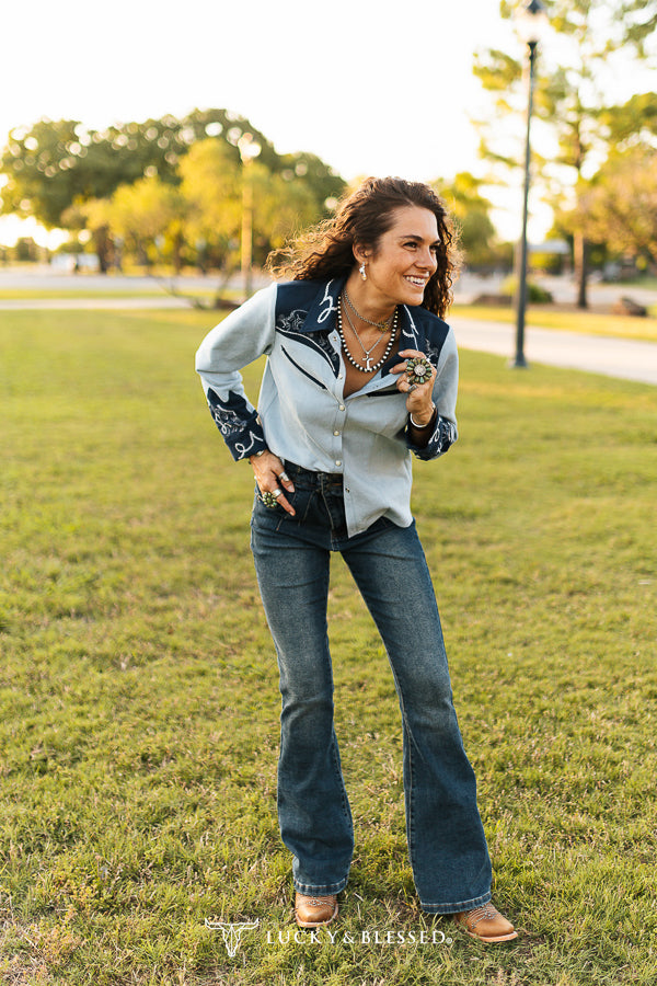 Pearl-snap and embroidery detail on blue western top