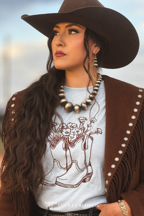 Light blue cowboy boot floral embroidered long sleeve top detail